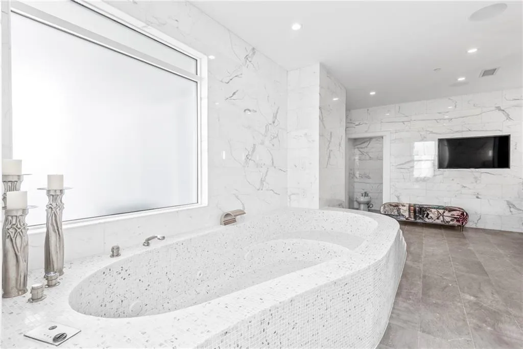 Recessed TV in the wall of this beautiful bath!