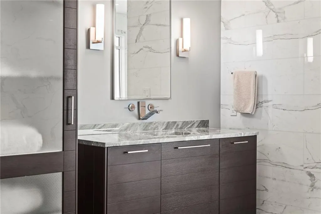 Beautiful faucets and lighting are contemporary details in this primary bath