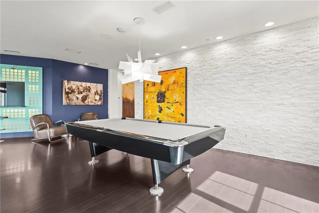 Stacked stone wall is perfect backdrop for this modern pool table