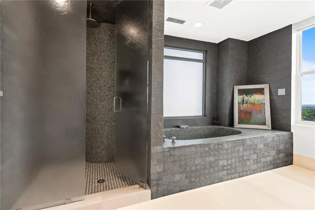 Oversized walk-in shower and stone bathtub