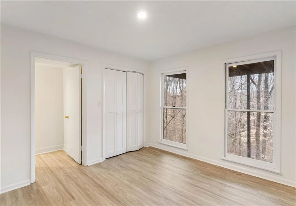 Unfurnished bedroom with a closet and light hardwood / wood-style floors