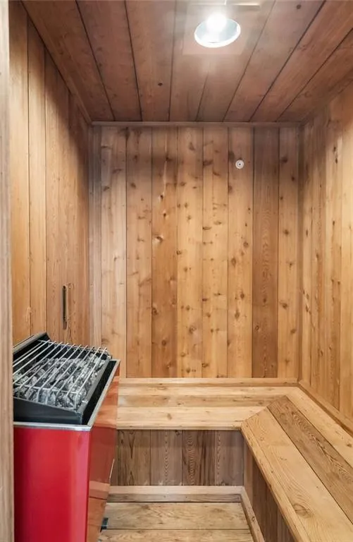 View of sauna / steam room featuring wood ceiling and wooden walls