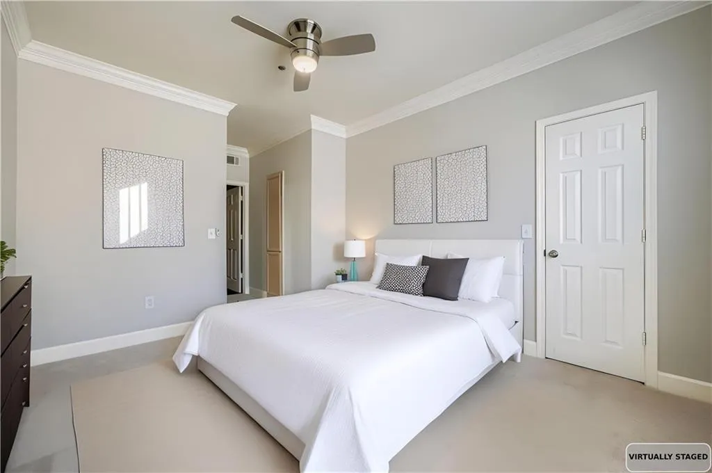 Bedroom featuring ornamental molding, a ceiling fan, and concrete floors