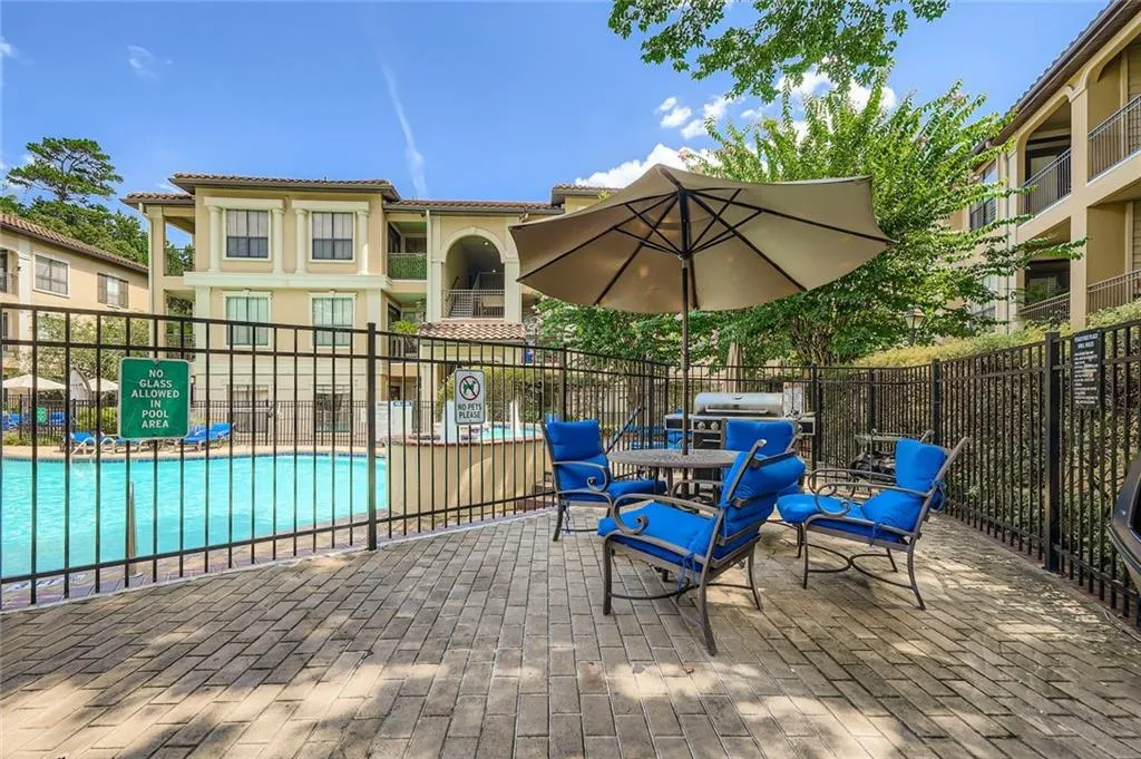 View of patio with a community pool