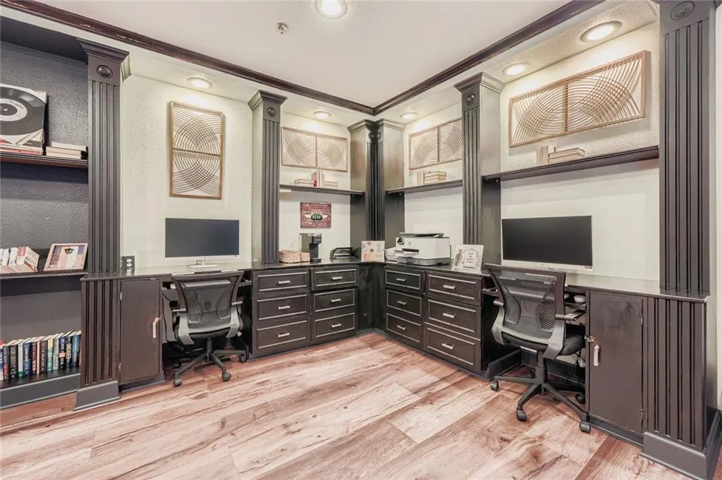 Home office with built in desk, ornamental molding, light wood-style flooring, and recessed lighting