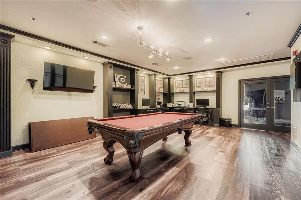 Game room featuring billiards, attic access, crown molding, light wood finished floors, and french doors