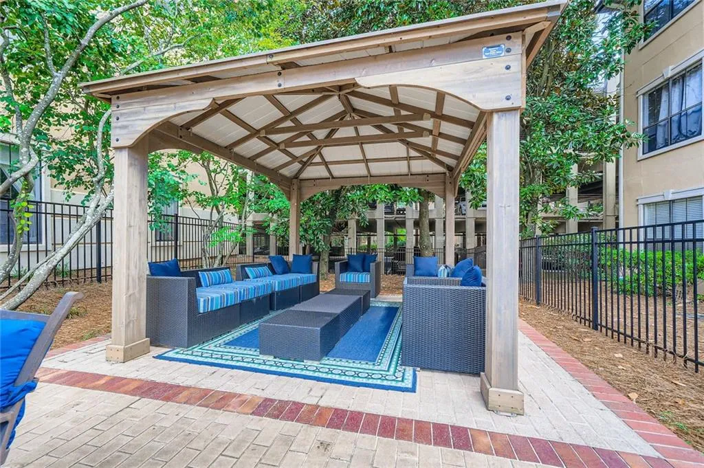 View of property's community featuring an outdoor living space, a gazebo, a fenced backyard, and a patio area