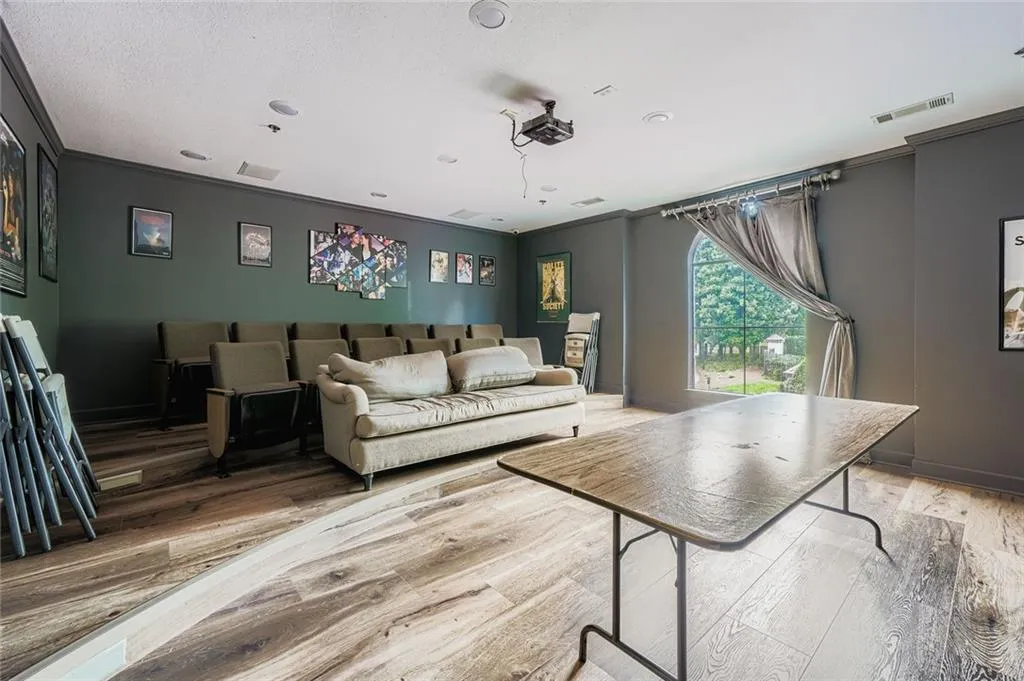 Living area with light wood-type flooring and crown molding