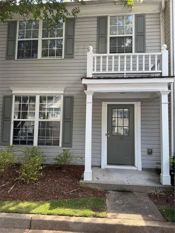 Gray siding exterior with white window trim and gray shutters