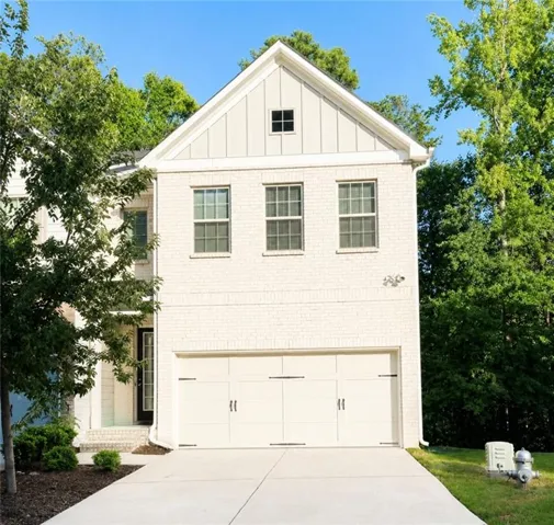 White brick facade with board-and-batten gable accent