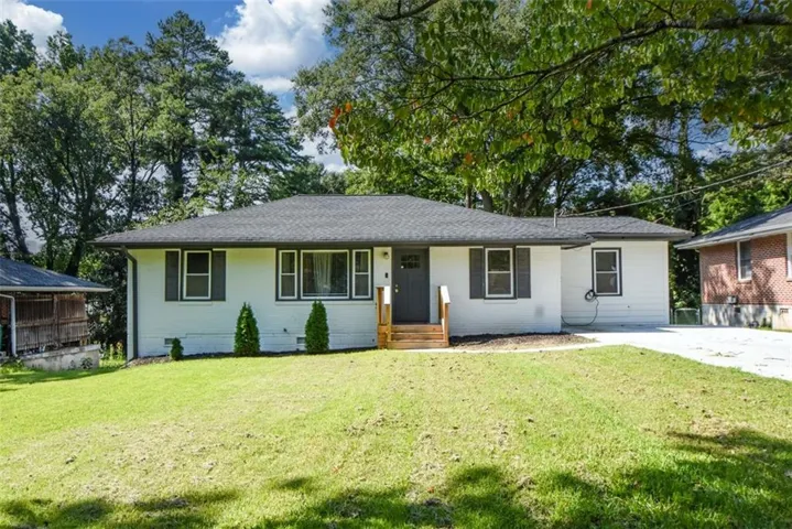 White exterior with dark trim and shutters, featuring a dark gray roof