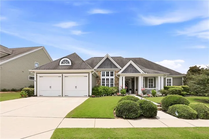 Ranch-style residence featuring a two-car garage with carriage-style doors