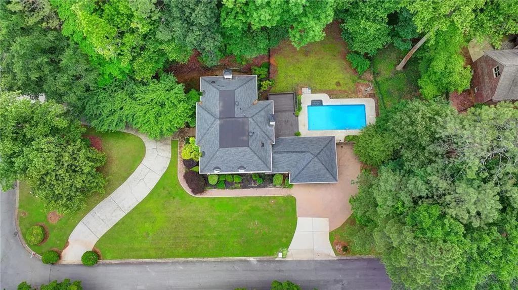 Aerial view of property and surrounding area with a pool area