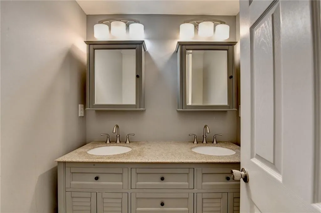 Basement Full bathroom featuring double vanity
