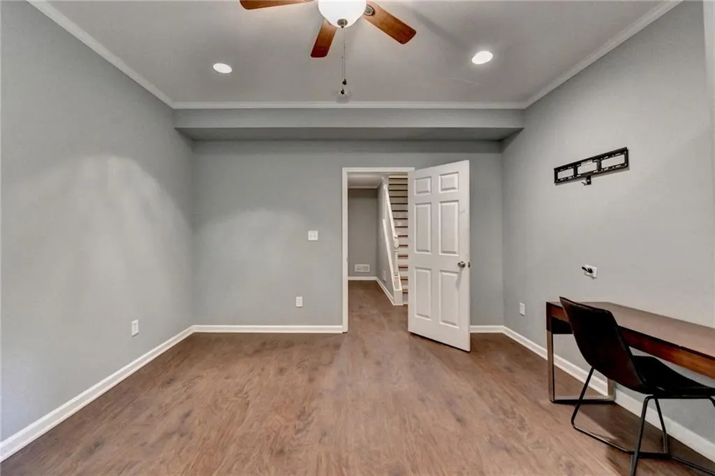 Basement Bedroom with ornamental molding, ceiling fan, wood finished floors, baseboards, and recessed lighting