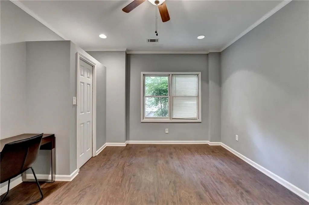 Basement Unfurnished bedroom with dark wood finished floors, crown molding, baseboards, a ceiling fan, and recessed lighting