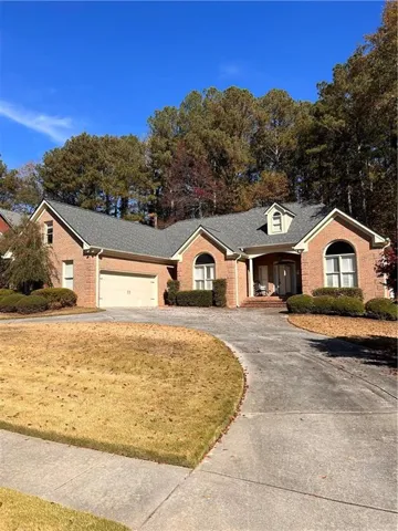 Single story home featuring a front lawn and a garage