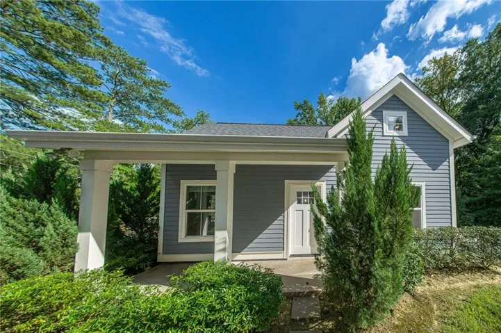 Light blue siding exterior with white trim and a covered porch