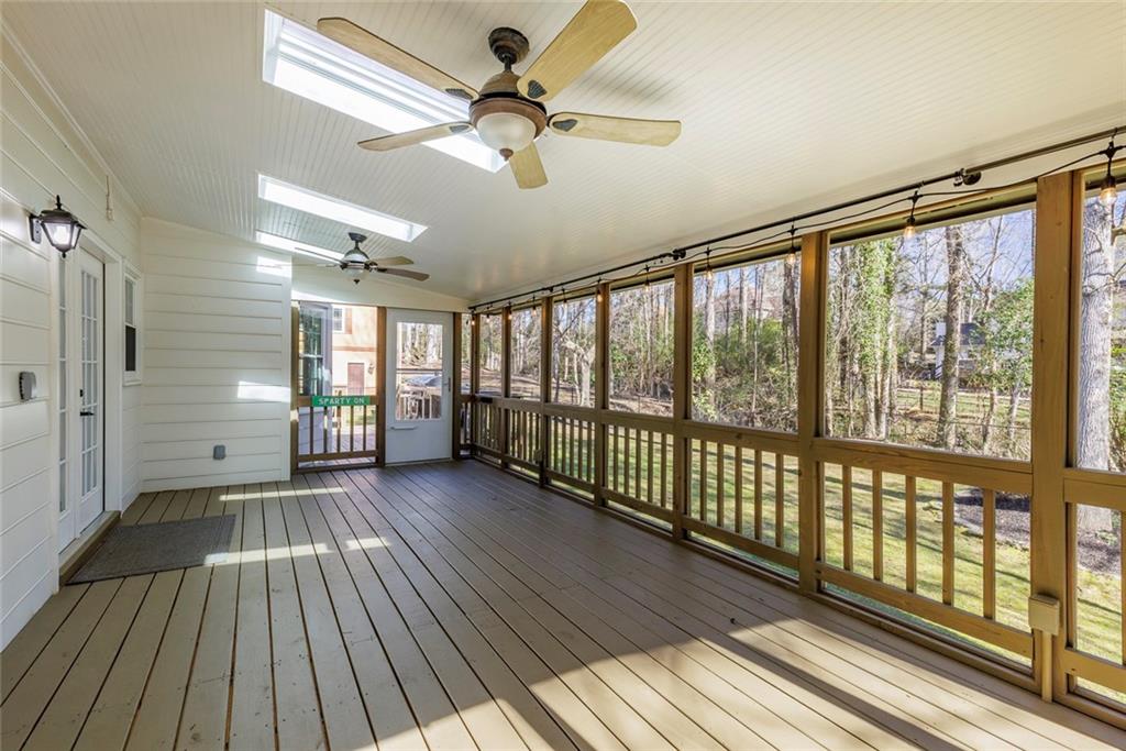 Screen porch with ceilings fans & new skylights.