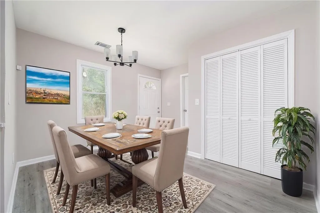 Dining room featuring light wood-style floors and a chandelier