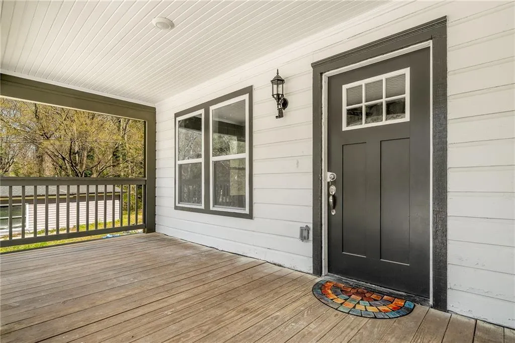View of exterior entry featuring a wooden deck
