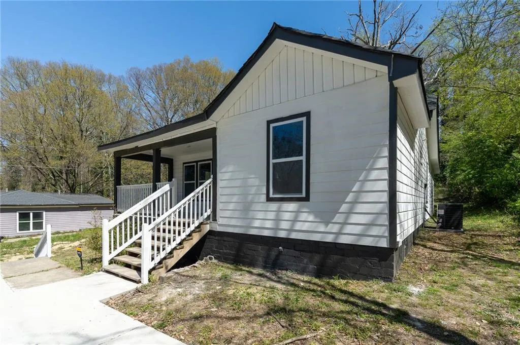View of front facade with covered porch and board and batten siding