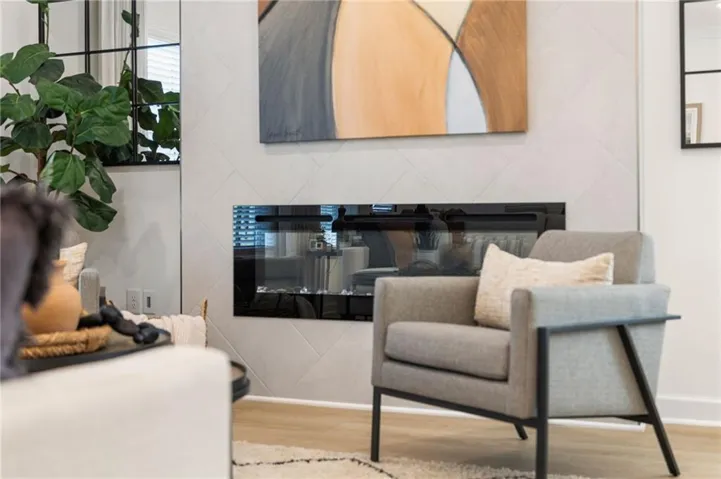 Built-in linear electric fireplace with a herringbone tile surround