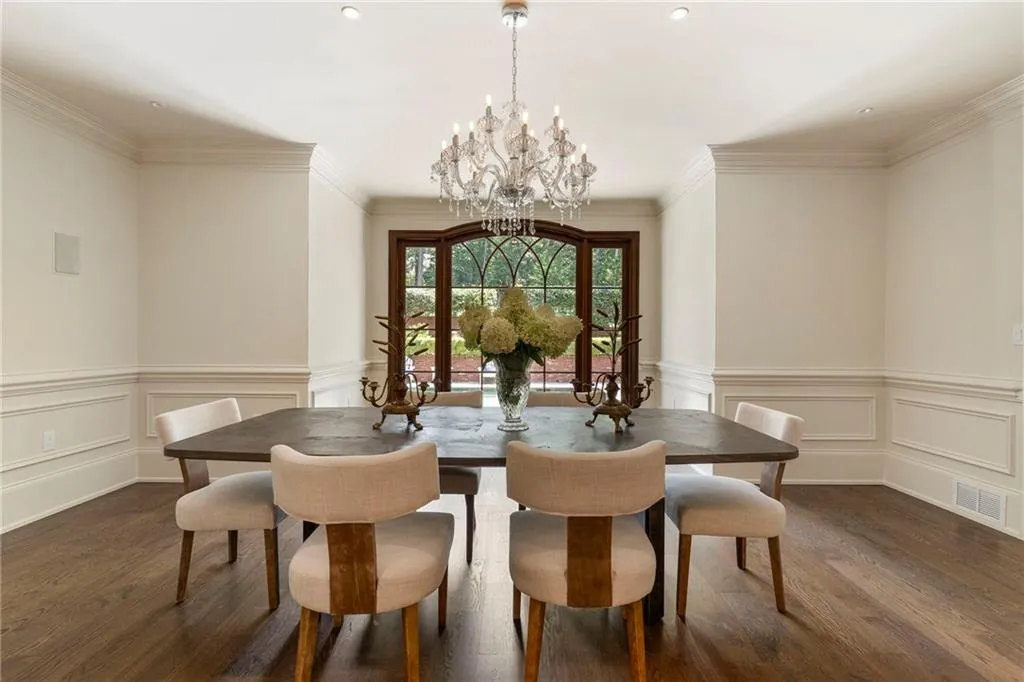 Dining room featuring a bay window with dark wood framing and decorative muntins
