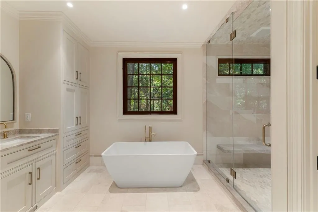 Freestanding soaking tub with gold-finish fixtures