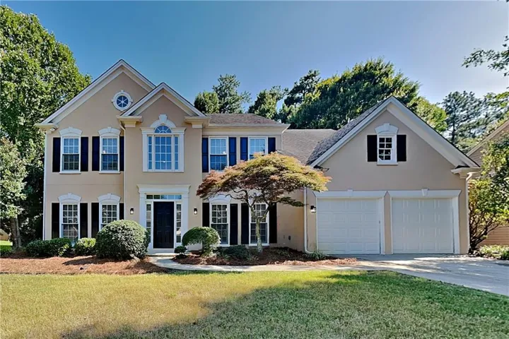 Stucco exterior with multiple gables and a two-car garage