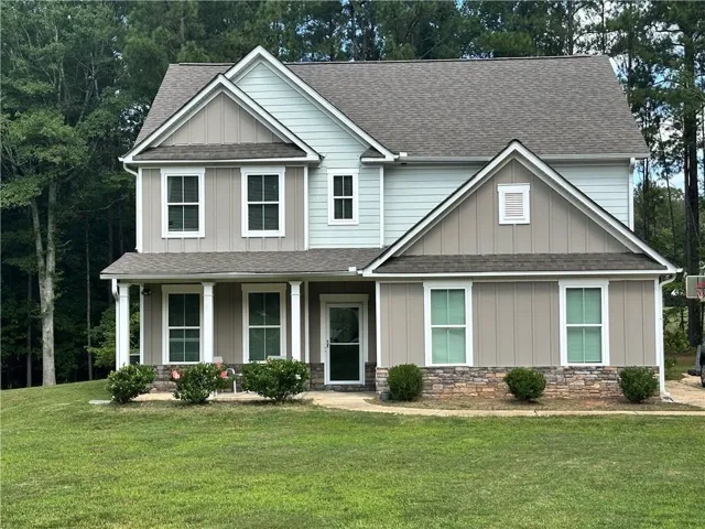 Two-story exterior with a covered front porch and stone accent detailing