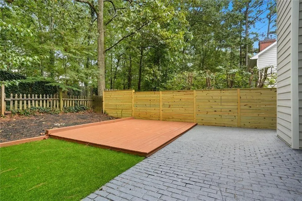 Fenced backyard featuring a wooden deck