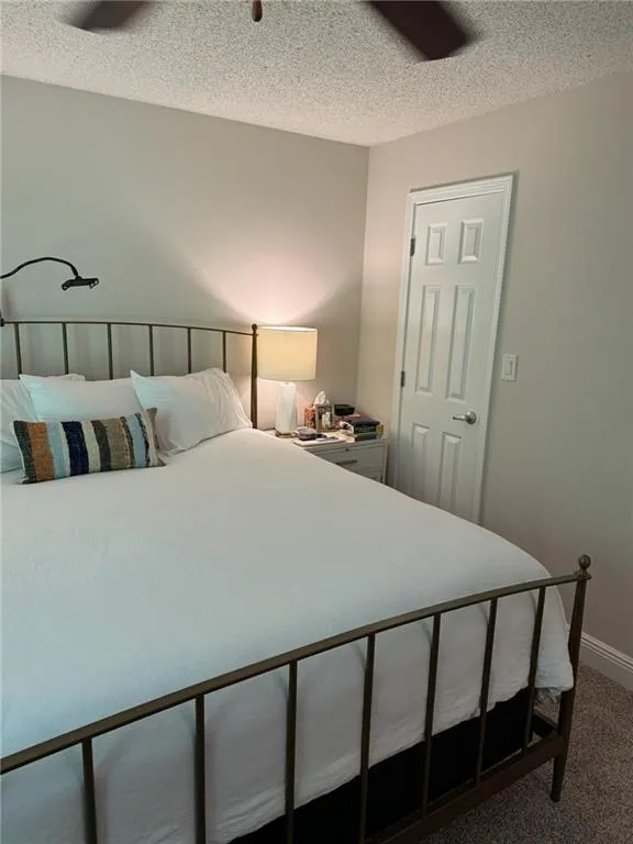 Carpeted bedroom with a textured ceiling