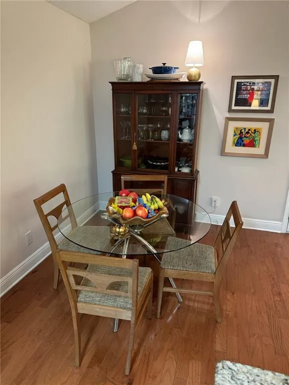 Dining area with hardwood / wood-style flooring