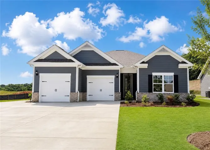 Contemporary exterior featuring dark gray siding, white trim, and a combination of brick and stone accents