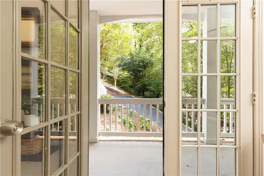 French doors open to front porch that overlooks creek