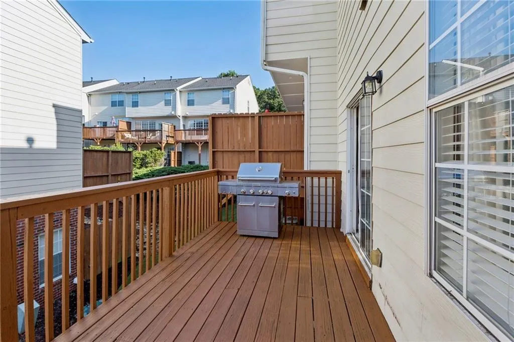 Wooden deck with a grill and a residential view