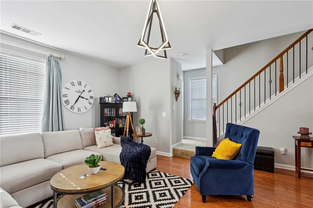 Living room with wood finished floors and stairway