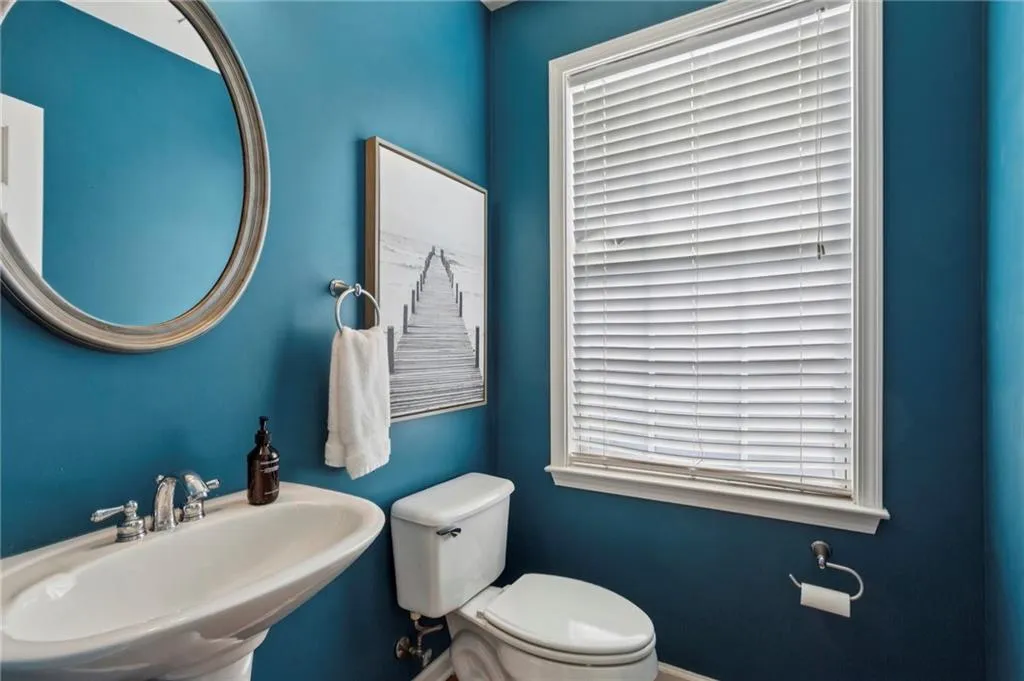 Half bath featuring a sink and toilet