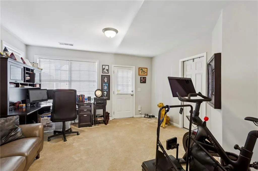 Entry level flex space perfect for home gym, office. Access to backyard patio.