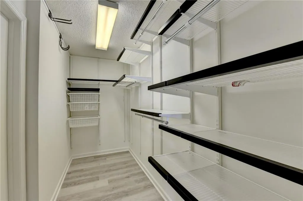 Spacious closet with light wood-style floors