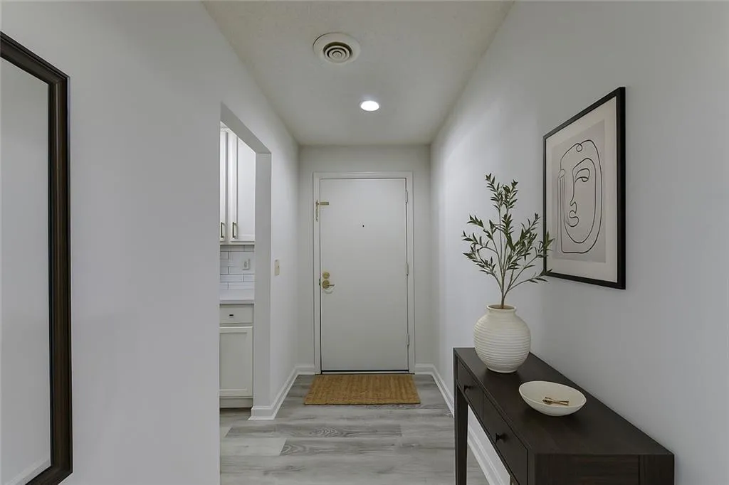 Entryway with wood finished floors and recessed lighting