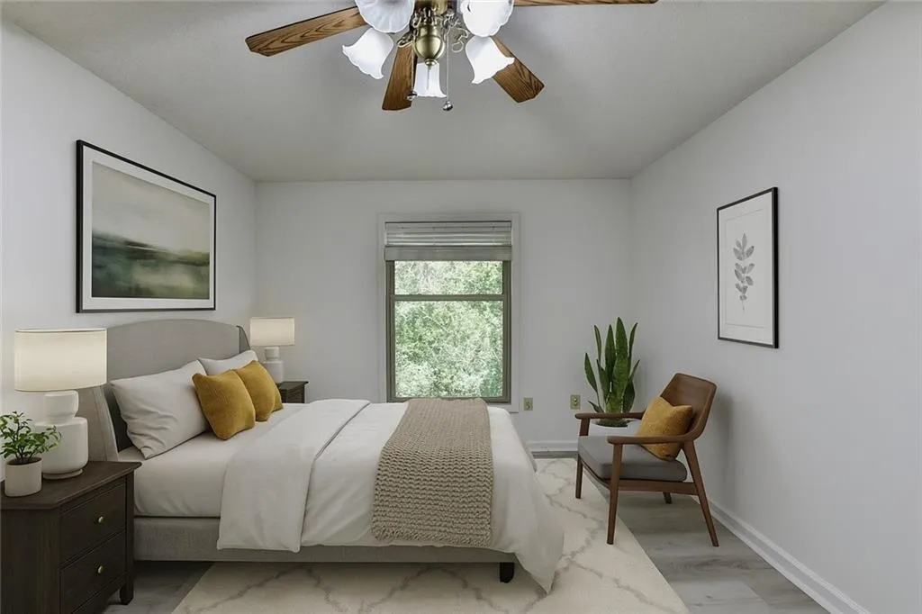 Bedroom with wood finished floors and a ceiling fan