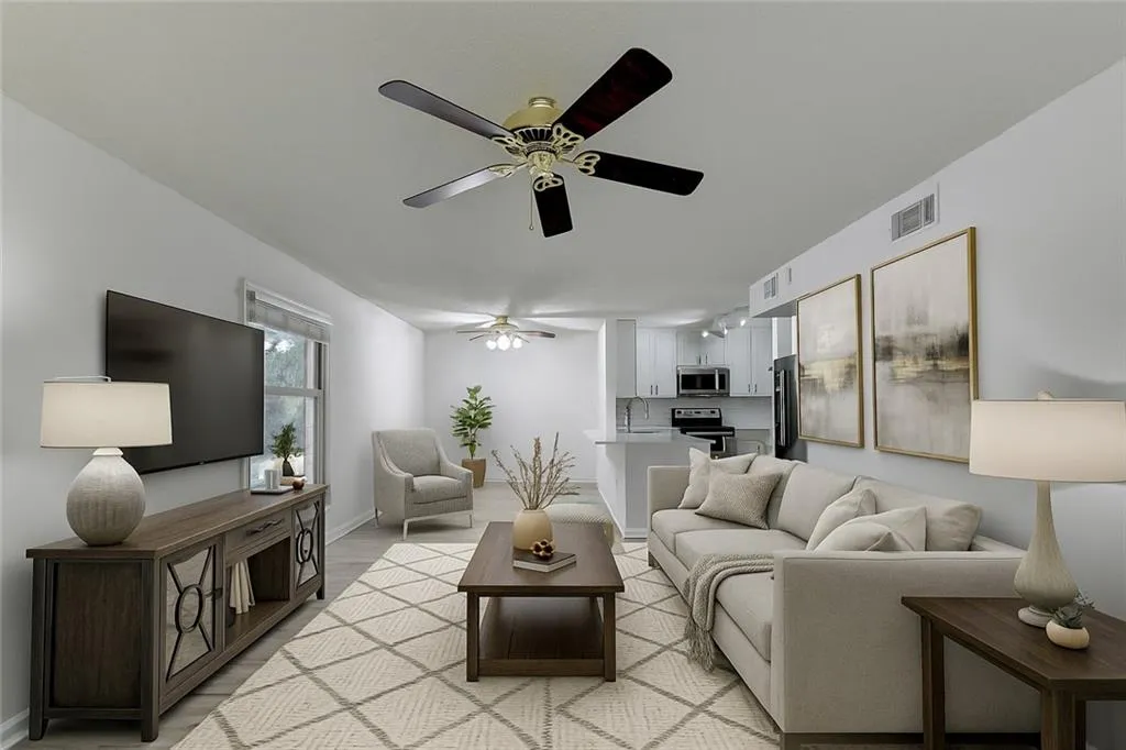 Living room with light wood-style floors and ceiling fan