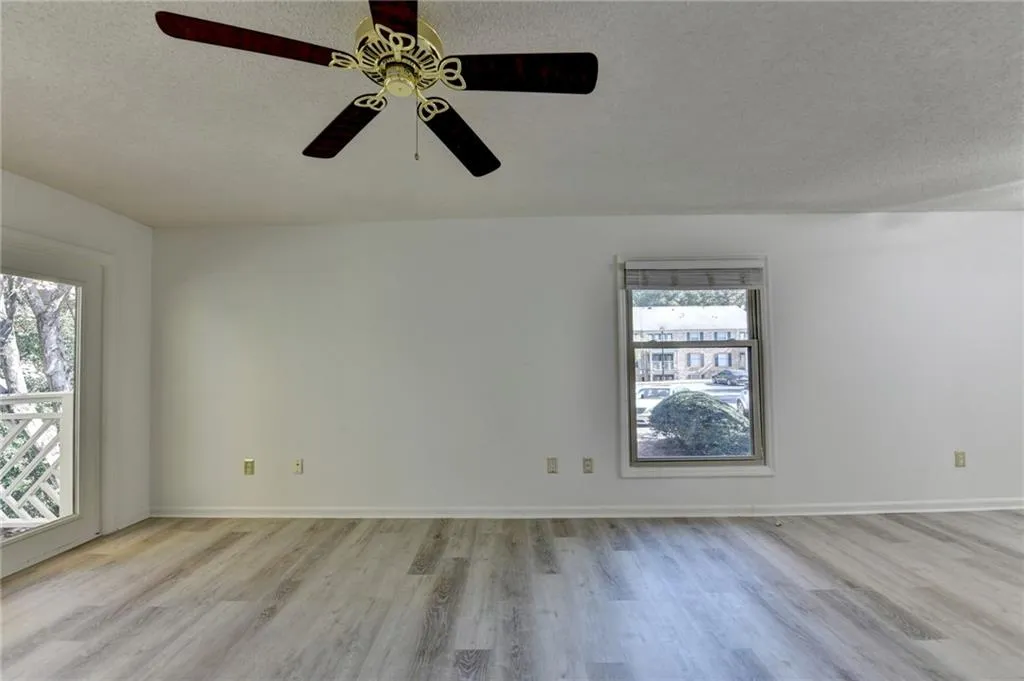 Unfurnished room featuring a textured ceiling and light wood finished floors