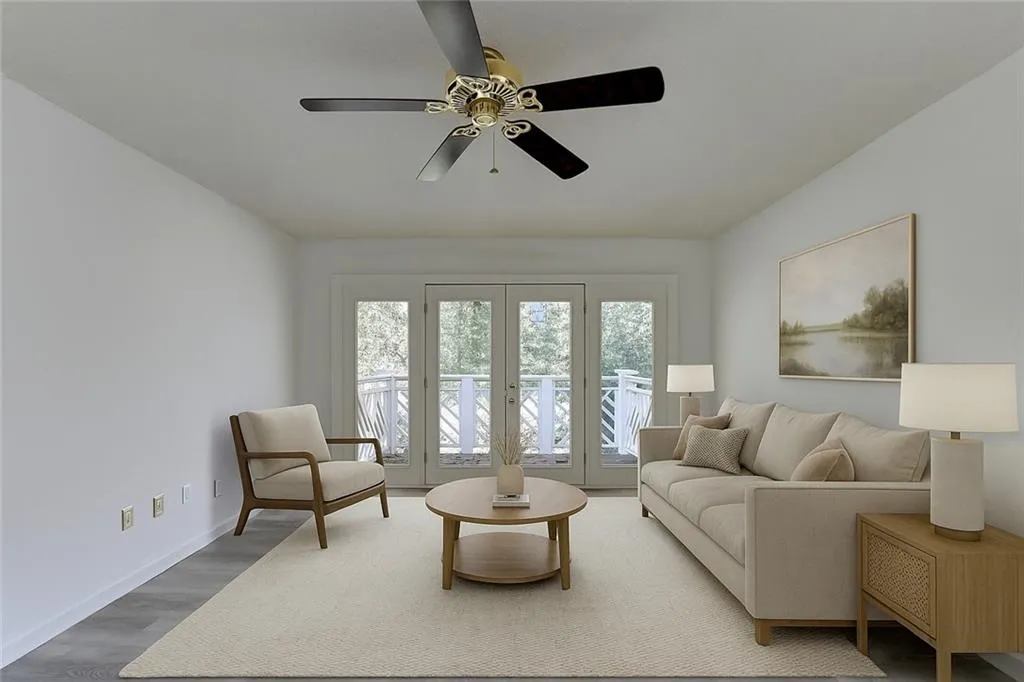 Living room featuring wood finished floors and a ceiling fan