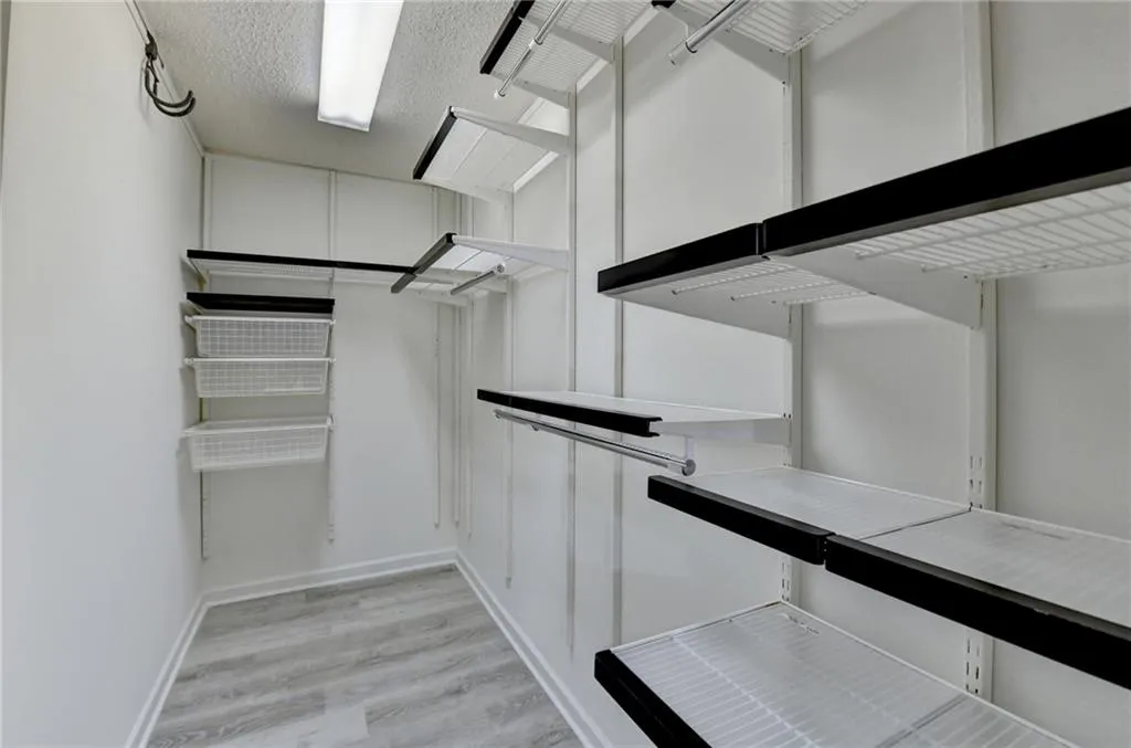 Walk in closet featuring light wood finished floors