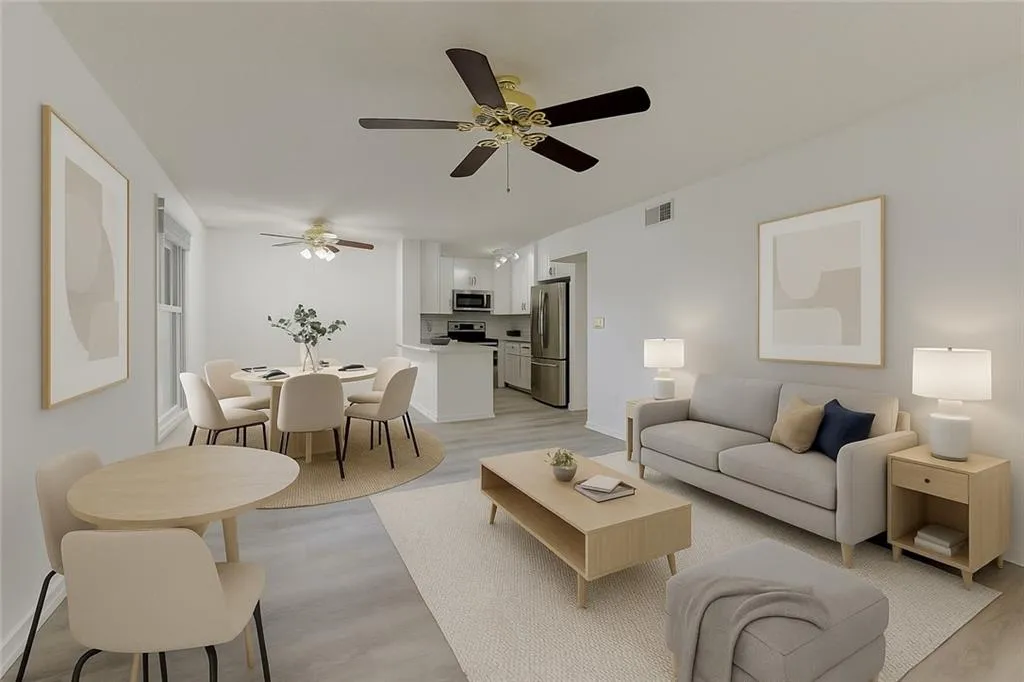 Living area with light wood-style flooring and ceiling fan