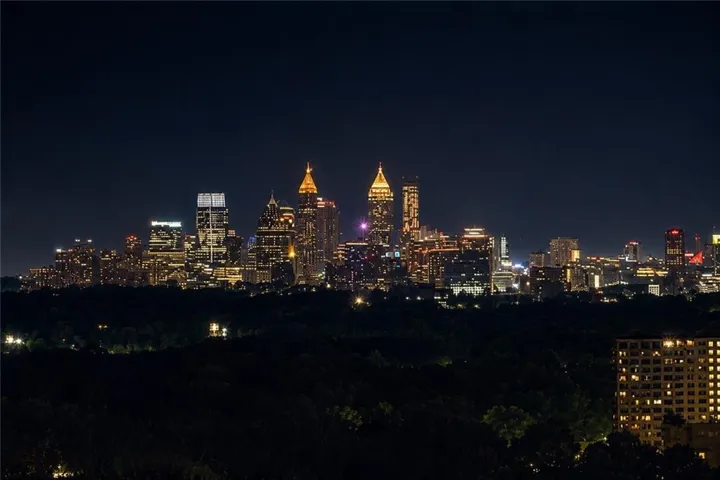 City lights begin to shimmer, the view of the Atlanta skyline