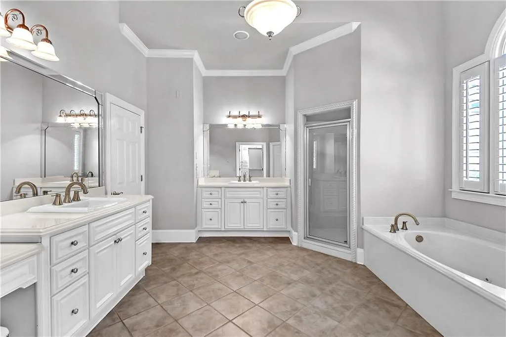 Bathroom featuring crown molding, tile flooring, and oversized vanity
